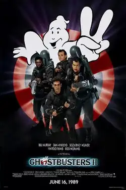 Bill Murray, Dan Aykroyd, Harold Ramis, and Ernie Hudson face the viewer. They are armed with slime throwing weapons resembling guns, with large tanks on their back. Behind them is a large logo of a "no ghosts" sign holding up two fingers. The logo "Ghostbusters&nbsp;II" is printed beneath them.