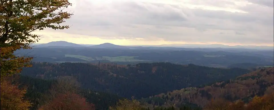 View from the Simmersberg (781&nbsp;m) in the Thuringian Highland of the Gleichberge, 24&nbsp;km away. Right rear: the Rhön and the Kreuzberg ({{Subst:Formatnum:927.8}}&nbsp;m), 67&nbsp;km away. Centre, half right: the Ratscher Bergsee lake, 7&nbsp;km away