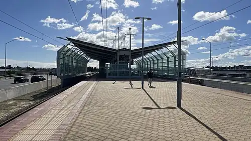 Looking north from the station platform showing the escalators as the left escalator is in use while the right escalator is under repairs.