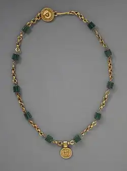Necklace with a medallion depicting a goddess; 30–300 AD; green glass (the green beads) and gold; length: 43.82 centimetres (17.25&nbsp;in); Los Angeles County Museum of Art