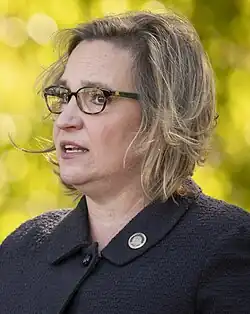 picture of this person at oppressive and they are wearing black they have dark blonde hair and they are wearing glasses