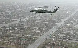 Marine One, carrying President George W. Bush, flies over the damaged city five days after the tornado.