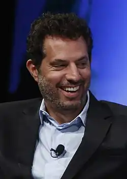 Guy Oseary smiling away from the camera.