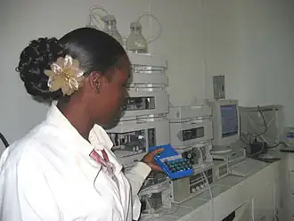 Image 3A technician at the Guyana Food and Drug Department Laboratory in Georgetown, Guyana selecting peanut samples to be tested with new equipment. (from Agriculture in Guyana)