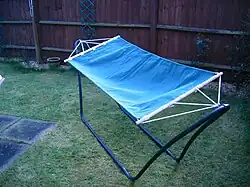 Hammock on a frame in a residential backyard