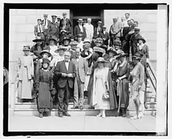 A 1920 photo of women and men of the National Women's party trying to convince Senator Harding to provide them with the 36th state.