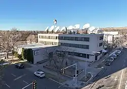 The KTVQ studios, a three-story building topped with satellite dishes