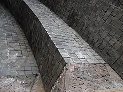 The arch ribs are made from blue engineering bricks laid in short courses only three bricks wide, using the stretcher bond. Six rings make up each rib.