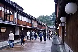 Small street lined by wooden two-storeyed houses.