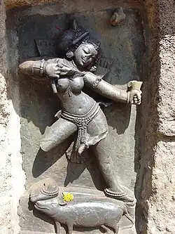 One of the Hirapur yoginis, with an offering of flowers at her feet