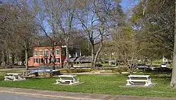 Looking across the park downtown towards the old Banks County Courthouse, the large brick building in the left background