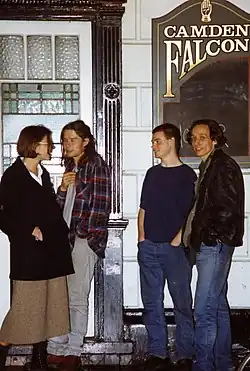 The band Hopper stood outside The Camden Falcon, a sign for the pub is visible