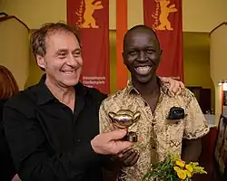 Juba Film Festival director Simon Bingo (Right) with Austrian filmmaker Hubert Sauper in 2014