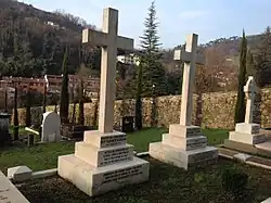 Two cross-shaped tombstones in a cemetery