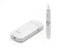 Philip Morris International's iQOS device with charger and tobacco stick.