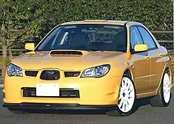 Subaru Impreza WRX STI spec C Type RA-R, a high-performance variant of the standard Subaru Impreza sedan. This photo shows the front of the car, which is yellow with white wheels.