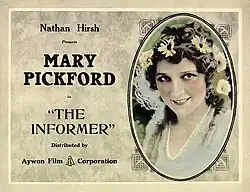 Tinted lobby card showing a close-up of Mary Pickford with daisies in her hair