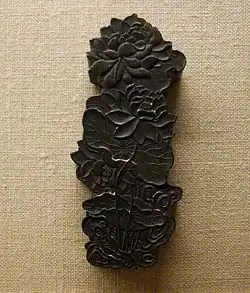 A Chinese inkstick, in the form of lotus flowers and blossoms. Inksticks are used in Chinese calligraphy and brush painting.