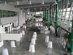 Airport terminal, with small round tables covered with large white tablecloths