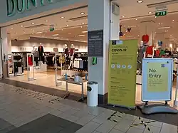 Supermarket: a one-way system, instructions on social distancing, disposable gloves, trolley cleaning supplies.