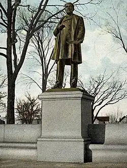 Bronze statue of man standing on a granite pedestal