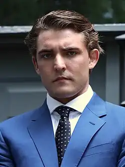 Jacob Wohl wearing a blue suit and black patterned tie