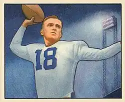 Football card illustration of Rauch wearing white jersey no. 18 and football pads (but no helmet), apparently preparing to pass the football.
