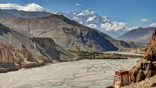 Kali Gandaki riverbed in Nepal's Upper Mustang. View from Thsele down to the Kali Gandaki river and the fields of Chusang village, with Nilgiri's steep north face.