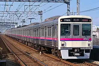 White commuter train with purple stripe