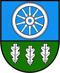 A coat of arms depicting a white wheel on a light blue background at the top and three white leaves on a green background at the bottom