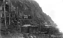 Ugiuvak about 1892. Walrus-hide summer houses and stone winter houses are visible.