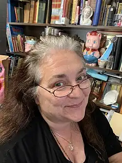 A picture of Kirsten Abrahamson smiling at the camera in her home office, June 25, 2020