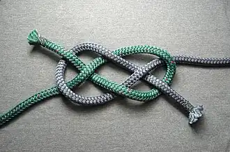 Tying starts with a diagonal carrick bend (two colors for clarity)