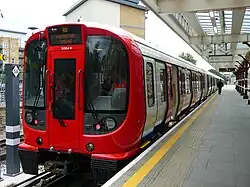 Red and grey train with unusually large windows