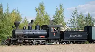Black tender locomotive with a spark-arresting chimney