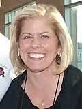 Laura Neuman smiling at an event in 2014
