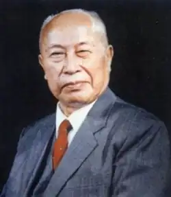 A colour portrait of a balding man in a suit