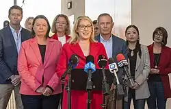 Saffioti talking at a press conference at a railway station with Labor politicians behind her