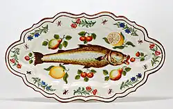 Polychrome maiolica dish with paintings of a fish, flowers and fruit, Lodi, 1751.