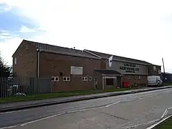 An image showing Long Buckby Rugby Club's clubhouse during a sunny day