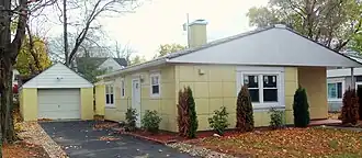 A similar house and garage in yellow