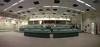 Mission Operation Control Room 2 in the Christopher C. Kraft Jr. Mission Control Center, from the front of the room looking back toward the visitor gallery (prior to the 2019 restoration)