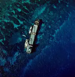Overhead view of a ship aground on a coral reef