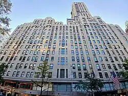 The exterior of the hotel as seen from Madison Avenue. The facade has windows of varying sizes. At the base are several storefronts.