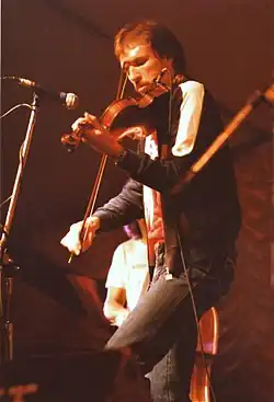 Musician Mark O'Connor playing a fiddle.