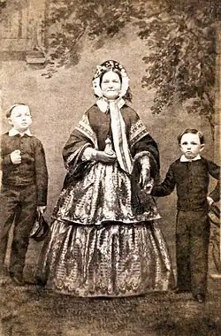 Black-and-white photo of a woman with two young boys