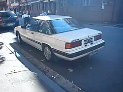 Rear of a second series Mazda 929 Coupé showing the now un-divided rear side windows and the tail lights with horizontal indents