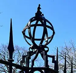 Armillary spheres on top of a wrought-iron fence