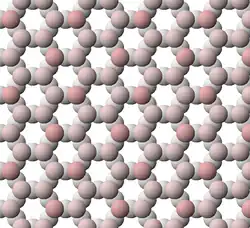 View of tetrahedral sheet structure of biotite. The apical oxygen ions are tinted pink.