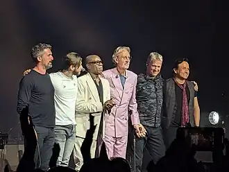 Mike And The Mechanics on tour in April 2025 L-R: Luke Juby, Nic Collins, Andrew Roachford, Mike Rutherford, Anthony Drennan and Tim Howar.